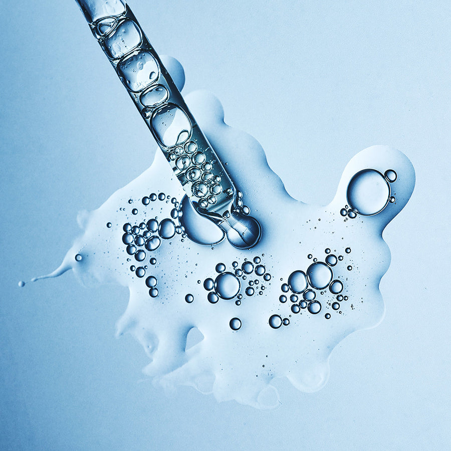 Hyaluronic Filler+ dropper with clear gel droplets showing the serum's texture